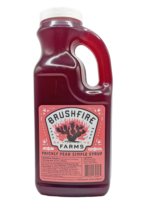 Bulk Prickly Pear Simple Syrup in a clear jug, featuring a vibrant pink color and Brushfire Farms branding.