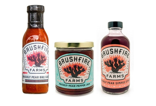 Three products from Brushfire Farms featuring prickly pear: BBQ sauce, pepper jam, and simple syrup in distinctive packaging.