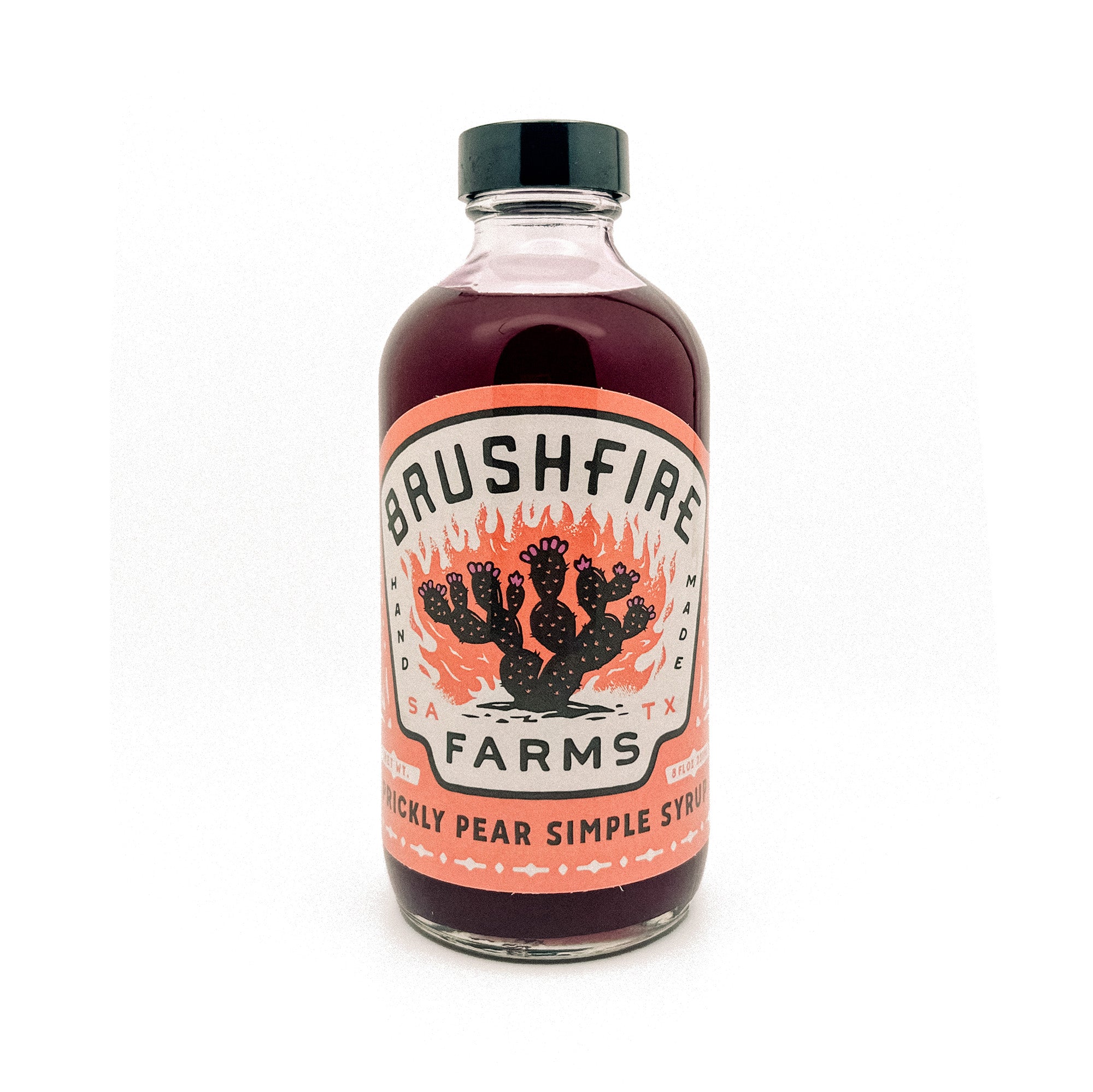 Prickly Pear Simple Syrup in a glass bottle with a vibrant label featuring cacti and Brushfire Farms branding.