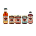 Assorted Brushfire Farms products including El Jefe original glaze, pepper jams, and prickly pear syrup in jars.